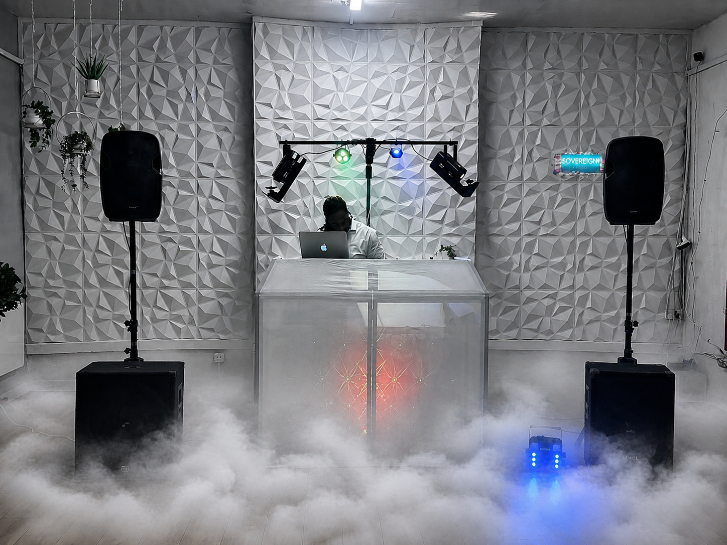 White DJ booth setup with low fog, disco lighting and geometric wall panels